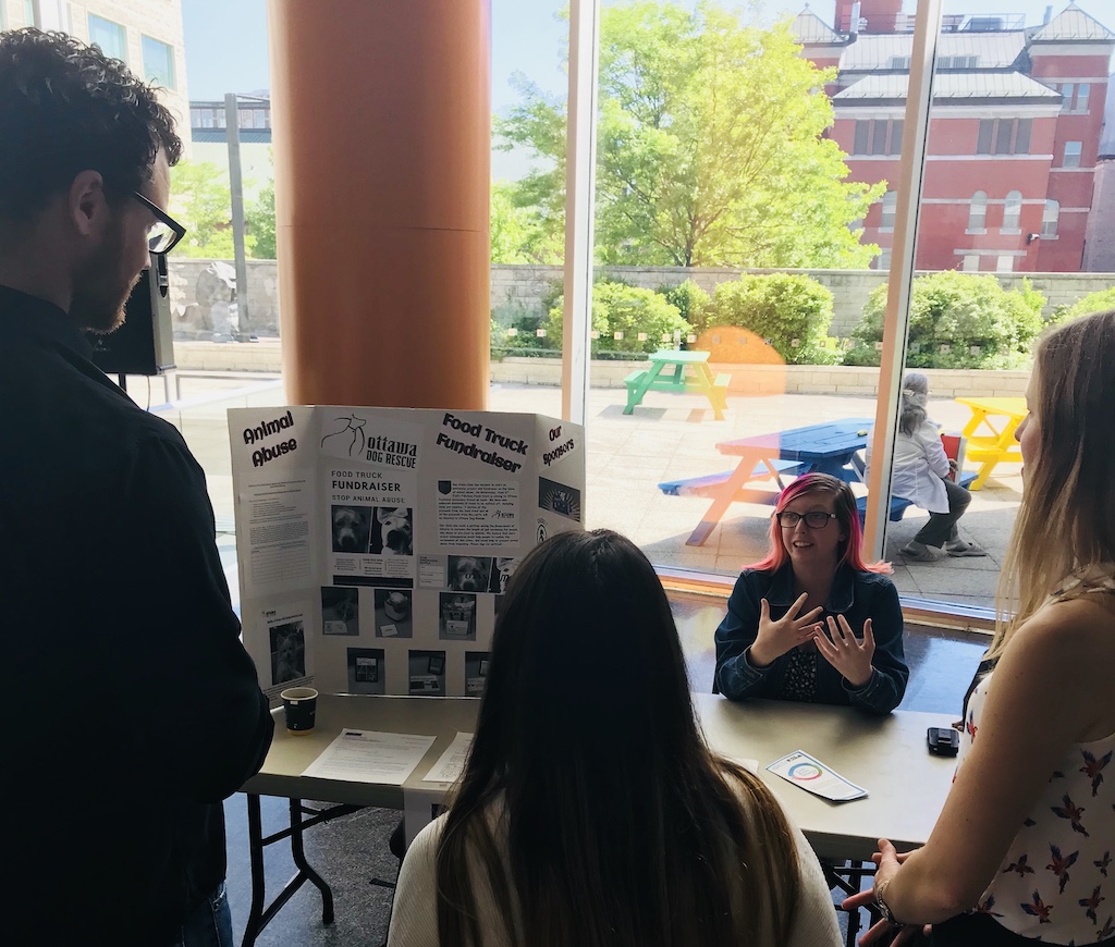 People listening to a student project presentation