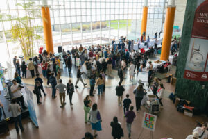 Overhead view of Ottawa City Hall during the Youth Action Untapped Showcase, there are around 100 people pictured